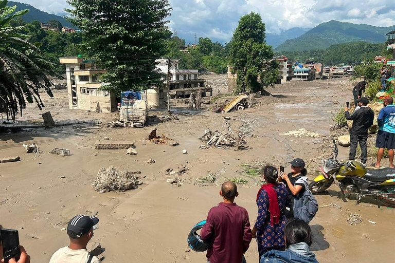 Photo: Rescue workers assist residents following floods and mudslides in Nepal. Credit: Navesh Chitrakar/Reuters.