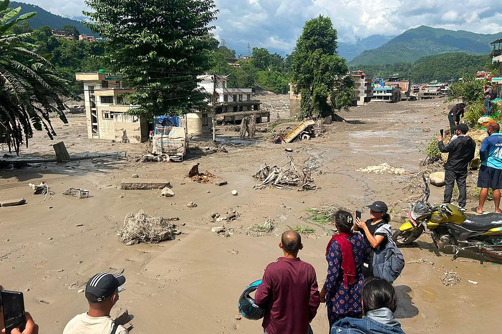 Photo: Rescue workers assist residents following floods and mudslides in Nepal. Credit: Navesh Chitrakar/Reuters.